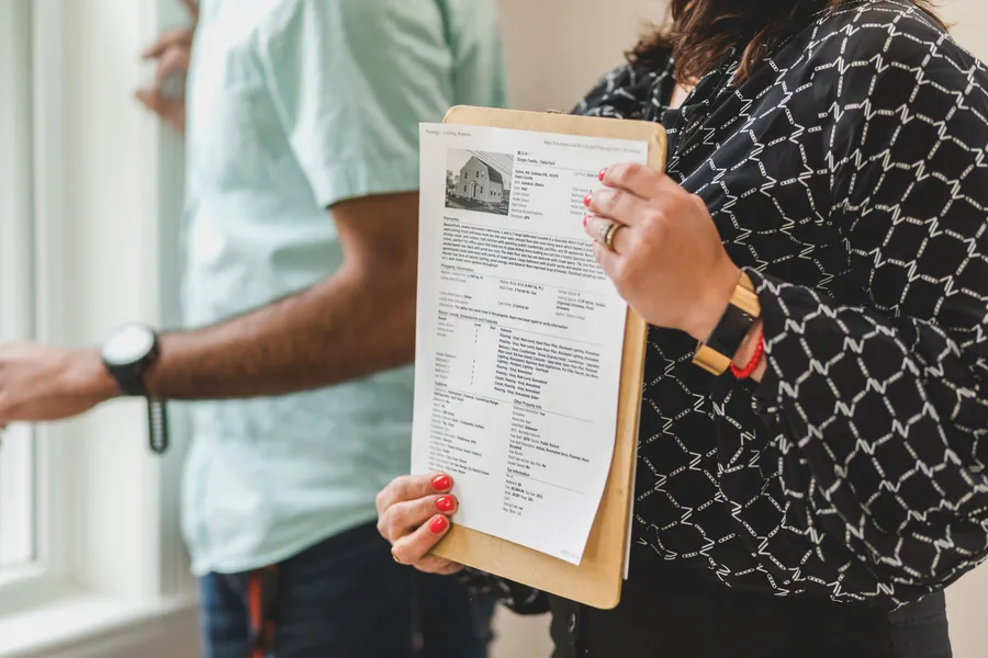 Property documents and report materials on a desk
